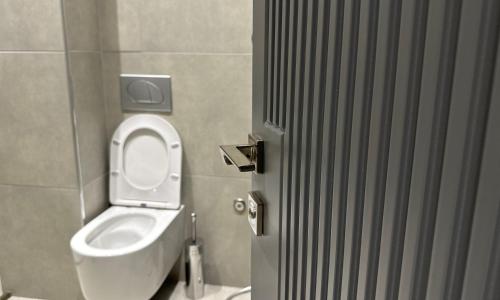 a bathroom with a toilet with the lid up at Anchor Luxury Rooms in Vlorë