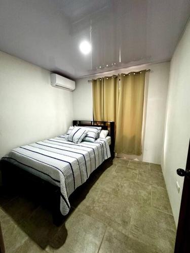 a bedroom with a large bed in a room at Ohana Beach House Costa Rica in Agujas