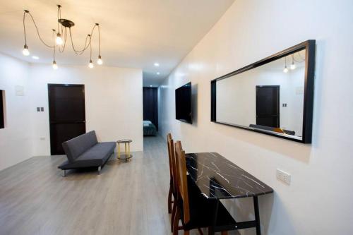 a living room with a table and a chair at Gray cozy unit in Valencia