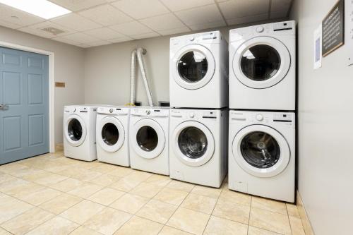 four washers and dryers in a laundry room at Staybridge Suites Buffalo by IHG in Buffalo