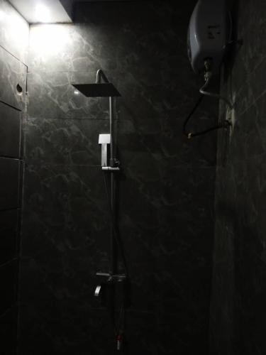 a bathroom with a shower with a light on the wall at Morada Hotels Ltd in Lagos