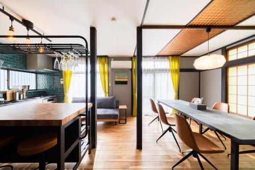 a kitchen and dining room with a table and chairs at 【海と城ヶ島大橋まで3分の貸切一軒家】ブルーピリオドMIURA in Moroiso