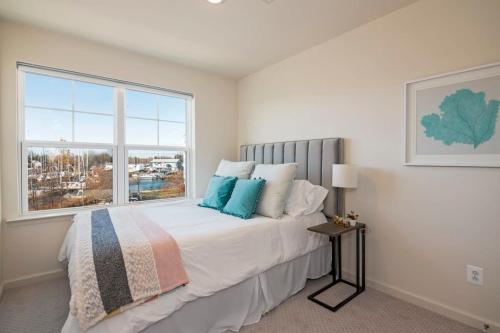a bedroom with a large bed with a window at New Intown Waterfront Townhome wPool & Location in Cambridge