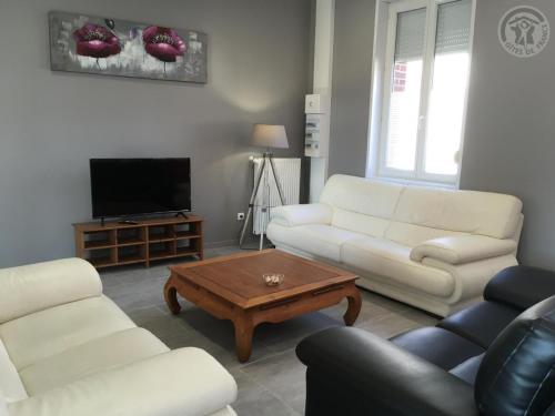 a living room with two white couches and a coffee table at Maison spacieuse pour 8 pers avec jardin, terrasse, WIFI, proche commerces et attractions culturelles - FR-1-510-156 in Aniche