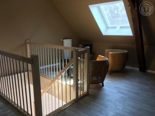 a staircase in a room with a skylight at Maison spacieuse pour 8 pers avec jardin, terrasse, WIFI, proche commerces et attractions culturelles - FR-1-510-156 in Aniche