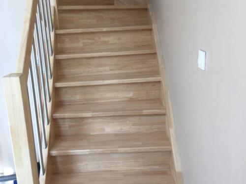 a staircase with wooden flooring in a house at Maison spacieuse pour 8 pers avec jardin, terrasse, WIFI, proche commerces et attractions culturelles - FR-1-510-156 in Aniche