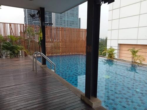 a swimming pool on the roof of a building at The Patra Hotel - Rama 9 in Bangkok