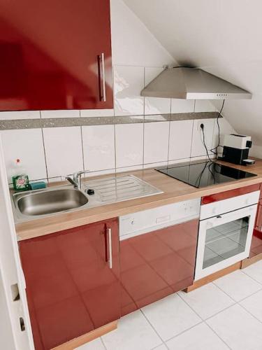 a small kitchen with a sink and a stove at Im Südviertel von Essen! FDG in Essen