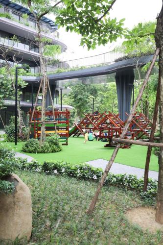a park with a playground in front of a building at 3Br Ecopark apt Onsen! Balcony lake view Free Pool in HÆ°ng YÃªn