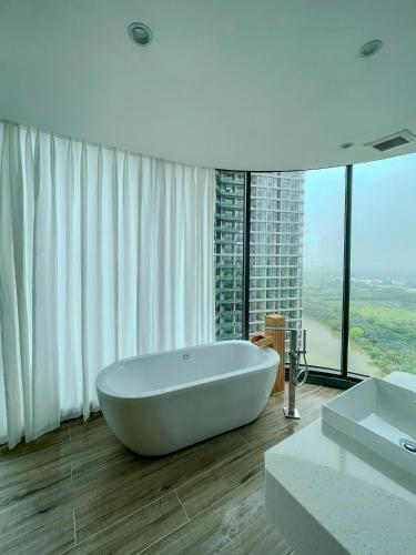 a white bathroom with a tub and a large window at 3Br Ecopark apt Onsen! Balcony lake view Free Pool in HÆ°ng YÃªn