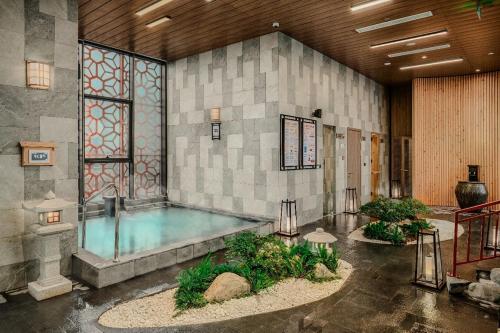 a large indoor pool in a building at 3Br Ecopark apt Onsen! Balcony lake view Free Pool in HÆ°ng YÃªn
