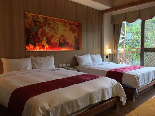 Ein Bett oder Betten in einem Zimmer der Unterkunft Ku Kuan Resort Hotel
