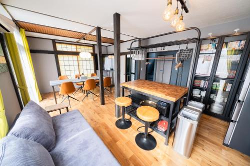 a living room with a couch and a table at 【海と城ヶ島大橋まで3分の貸切一軒家】ブルーピリオドMIURA in Moroiso