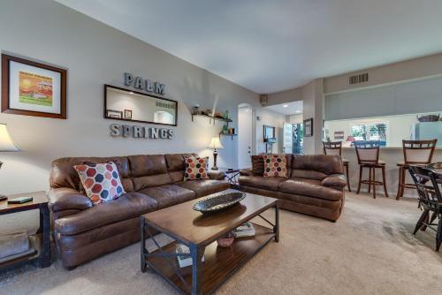 a living room with brown leather couches and a table at Desert Country Club Paradise! in Cathedral City