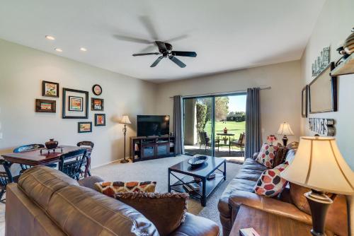 a living room with a couch and a tv at Desert Country Club Paradise! in Cathedral City