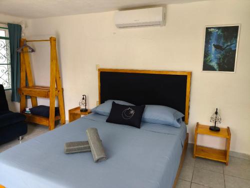 a bedroom with a bed with a cross on it at Studios Yaxkin, located in downtown in Cozumel