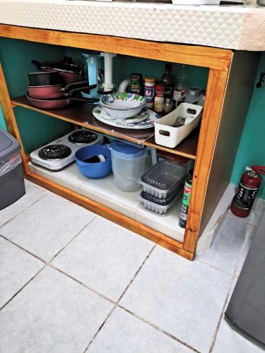a cabinet filled with dishes and utensils at Studios Yaxkin, located in downtown in Cozumel
