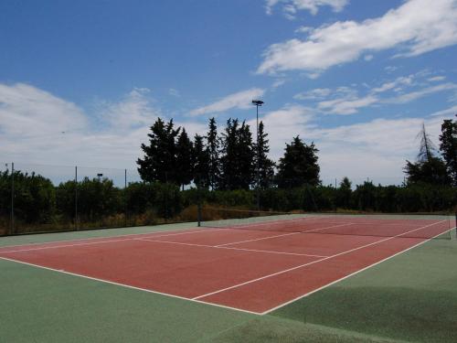 a tennis court with a tennis court at Borgo Valle Rita in Ginosa Marina