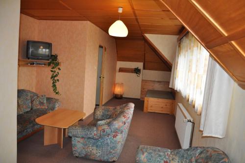 a small living room with a couch and a table at Pension Nostalgie in Beroun