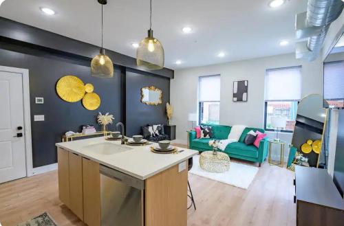 a kitchen and living room with a green couch at Modern Suite OTR PAYCOR STADIUM in Cincinnati
