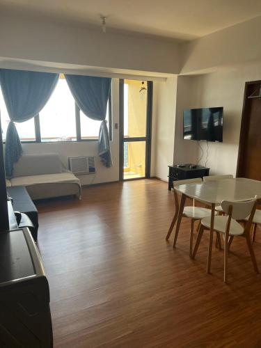 a living room with a table and a couch at Splendido Tagaytay Taal Lake Staycation Free Parking Netflix No Free Pool in Tagaytay