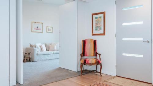 a living room with a chair and a couch at Bellas Block in Shoreham