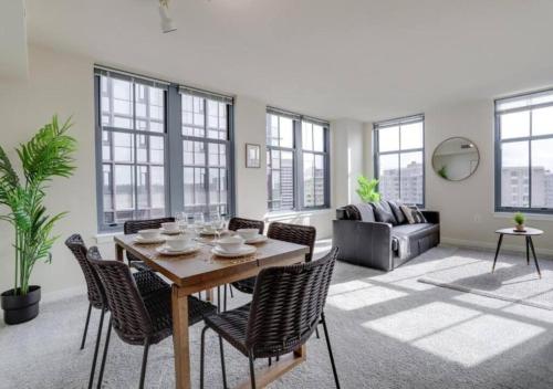 a living room with a wooden table and chairs at Splendid 2 BR Condo At Pentagon City in Arlington
