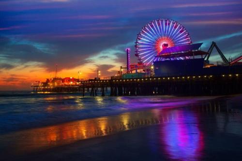 a ferris wheel at a carnival on the beach at night at The Carlton - Modern-Lux 2 Master Suites-Secure Bldg & Parking- 5 BLKS to Ocean Ave in Los Angeles