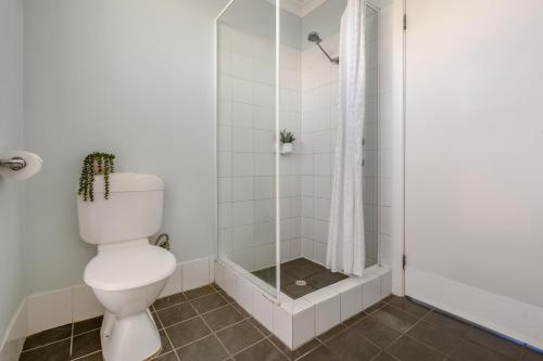 a bathroom with a toilet and a shower at BIG 4 Tasman Holiday Parks - Ledge Point in Ledge Point