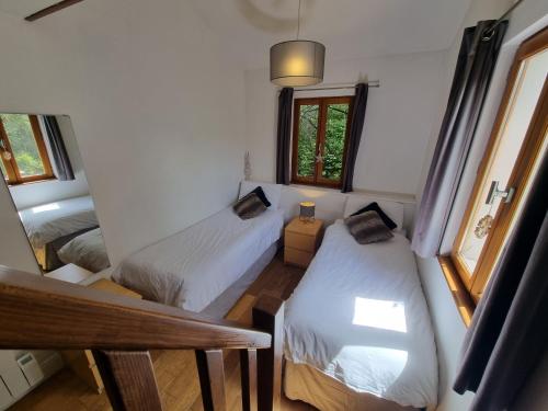 a small bedroom with two beds and a window at Chalet Broski - Luxury near St Martin De Bellville in Planvillard