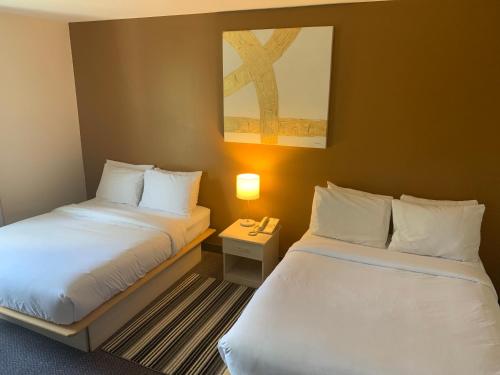 Katil atau katil-katil dalam bilik di Hôtel Saint-Côme