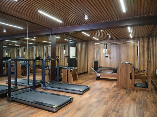 a gym with a bunch of exercise equipment in it at Ancient Huế Garden Houses in Hue