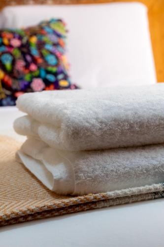 a pile of towels sitting on top of a table at Huallata Hotel Boutique in Huaraz