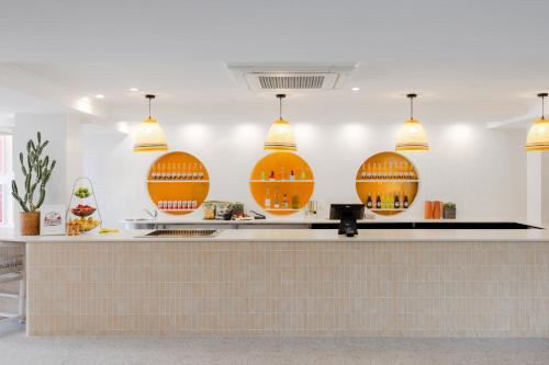 a kitchen with five basketballs on the wall at Hotel Hacienda in Sydney