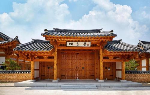 a wooden building with a sign on it at Hanok Stay Namwonyechon by Kensington in Namwon