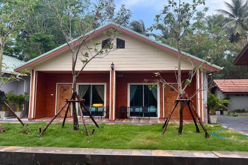 a small house with two telescopes in front of it at Phenwaree Amphawa Resort in Ban Dao Dong