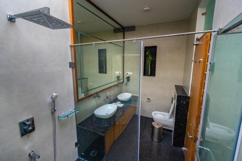 a bathroom with two sinks and a mirror at S R Premium Suites in Mysore