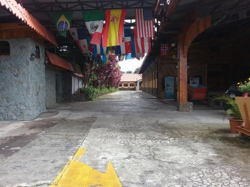 an empty street with flags hanging from a building at Hotel Cibeles Resort in Heredia