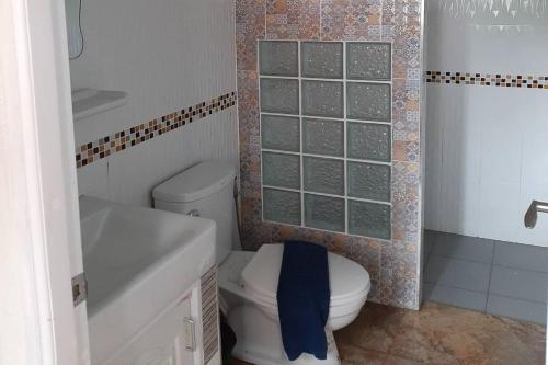 a bathroom with a white toilet and a sink at Phenwaree Amphawa Resort in Ban Dao Dong