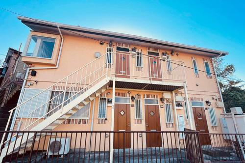 a house with a staircase on the side of it at Yokohama Ivy 103 - 横浜アイビー清水ヶ丘103 - in Yokohama