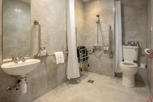 a bathroom with a toilet and a sink at Crowne Plaza - Sheffield by IHG in Sheffield