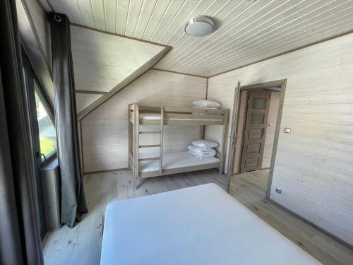 a small room with a bunk bed in a tiny house at Amelia Resort in Sianozety