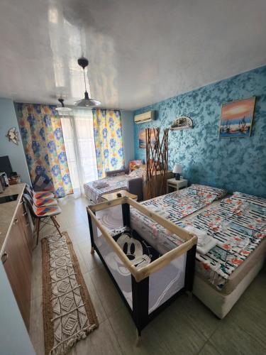 a bedroom with two twin beds in a room at Студио в Затворен Комплекс Blue in Sozopol