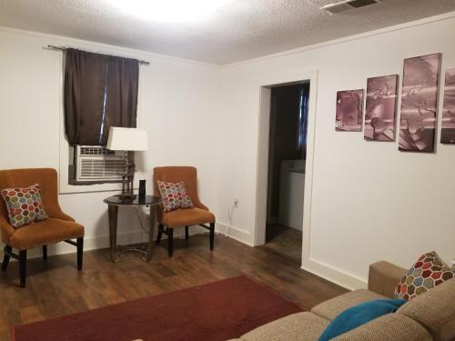 a living room with two chairs and a table at Private Room in Cozy home in Memphis