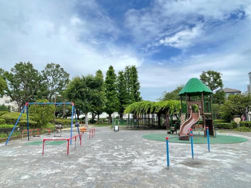 a park with a playground with a slide and swings at スカイツリーコテージ in Tokyo