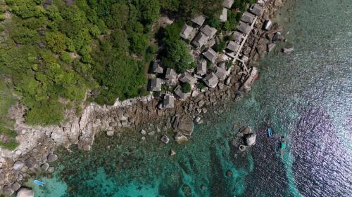 an aerial view of a beach with houses and the ocean at OK2 Mamajim Bungalows in Koh Tao