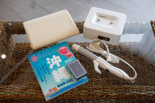 a wicker basket with a book and an electronic device at 崎本部戸建プール付き g棟 in Motobu