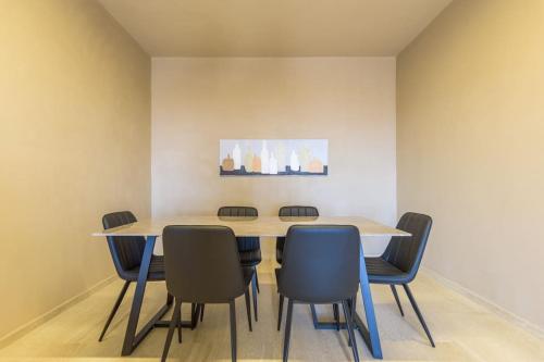 a dining room with a table and chairs at Soukside Haven 3BR 24-7 Electricity in Batroûn