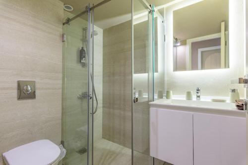 a bathroom with a shower and a toilet and a sink at Soukside Haven 3BR 24-7 Electricity in Batroûn
