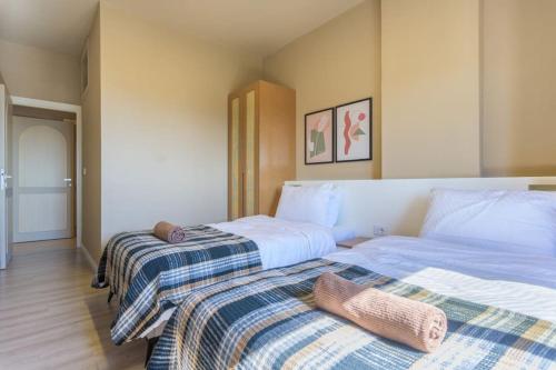 two beds sitting next to each other in a bedroom at Soukside Haven 3BR 24-7 Electricity in Batroûn
